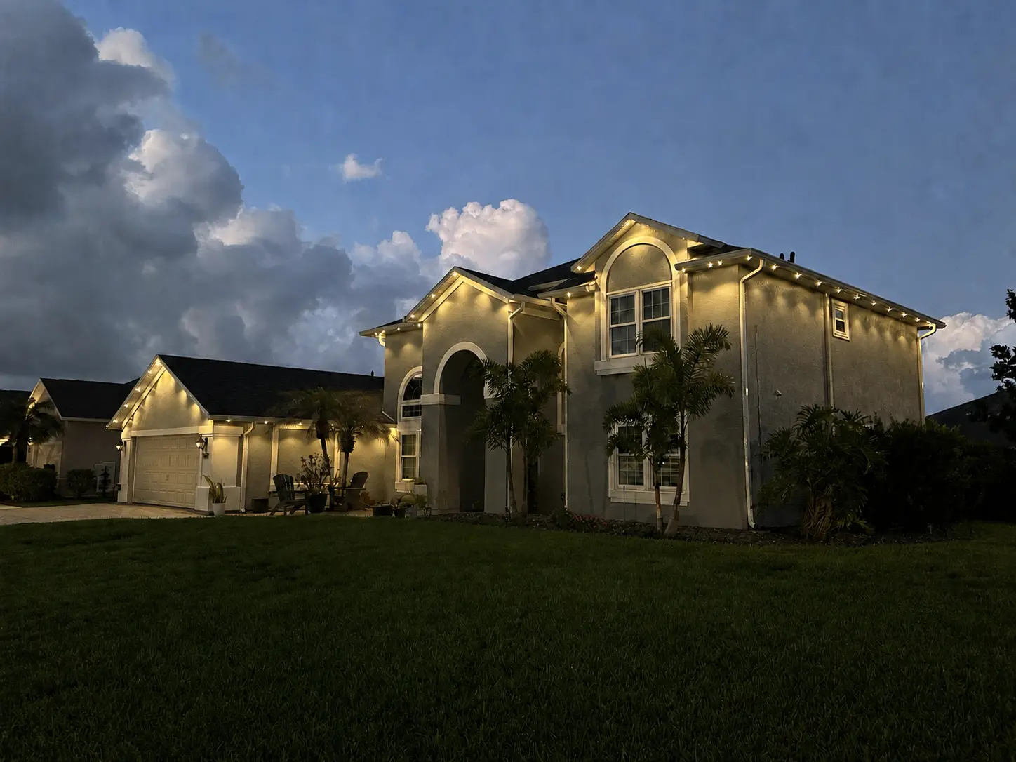 Permanent Christmas light installation Melbourne Florida luxury home exterior at dusk