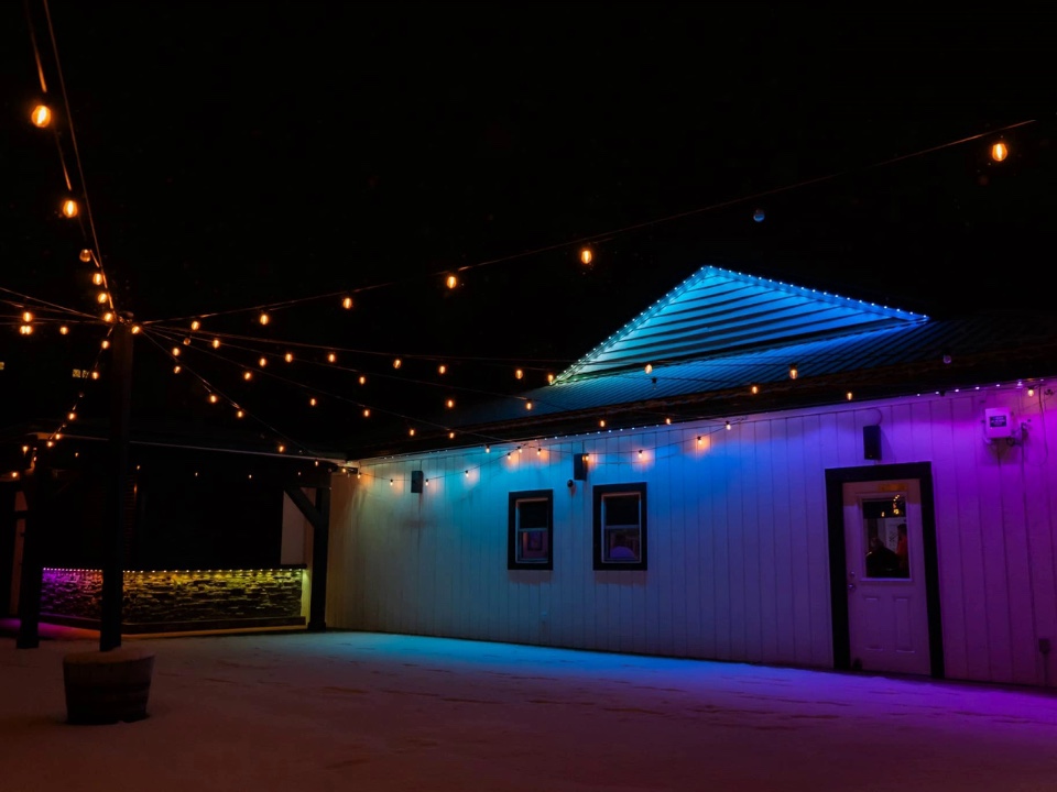 Patio string lights and RGB roofline lighting in an outdoor living space