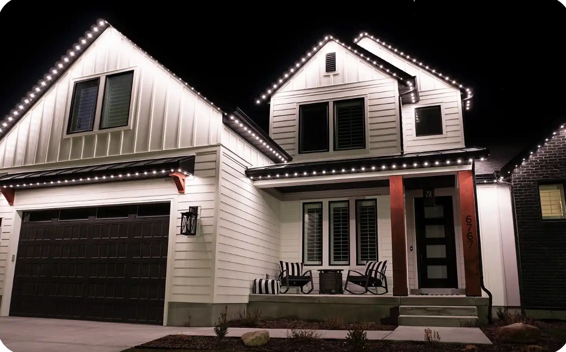 House with permanent roofline lighting at night
